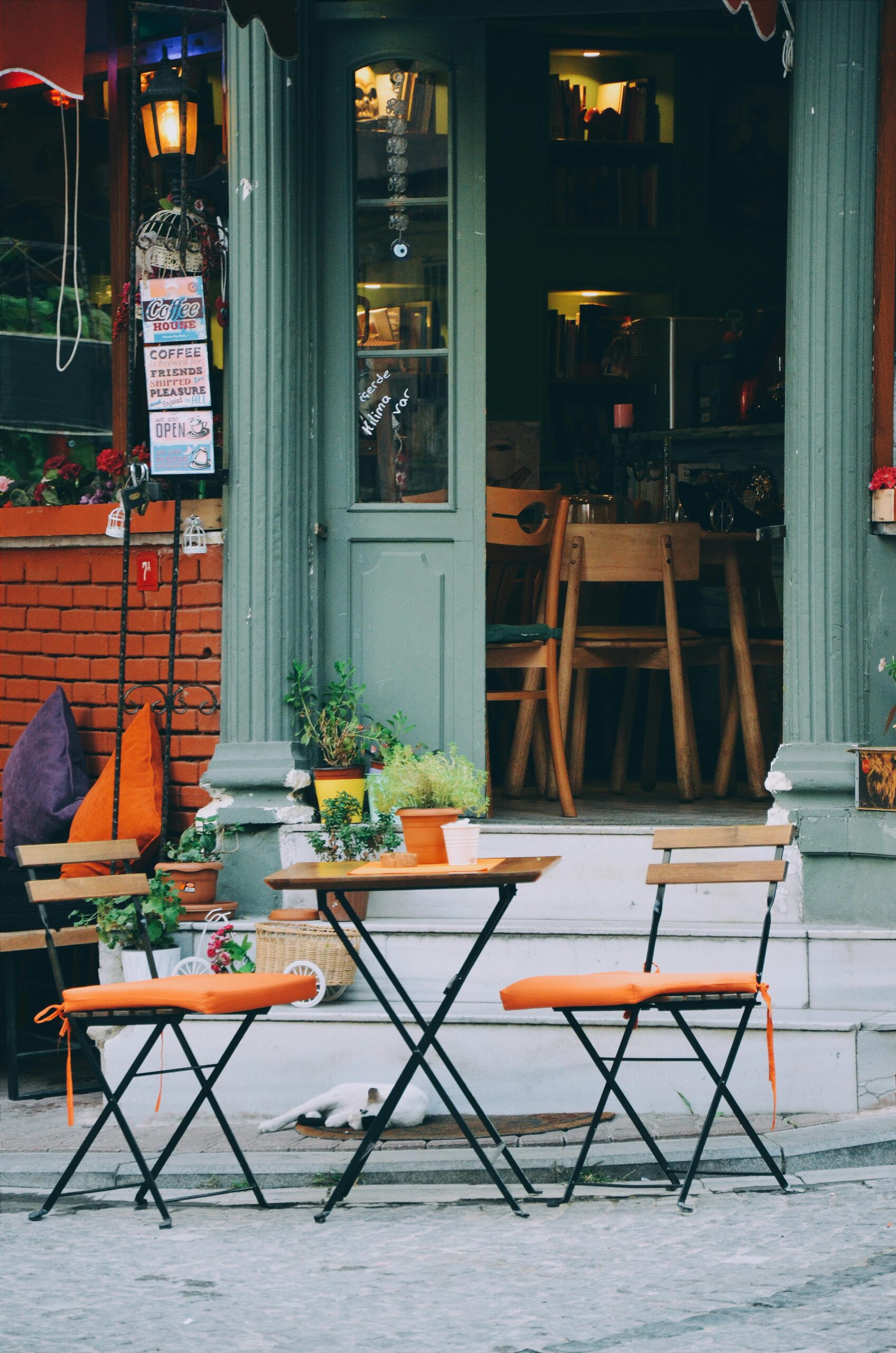 Cozy outdoor café with colorful chairs and rustic design. Ideal for travel and urban lifestyle imagery.